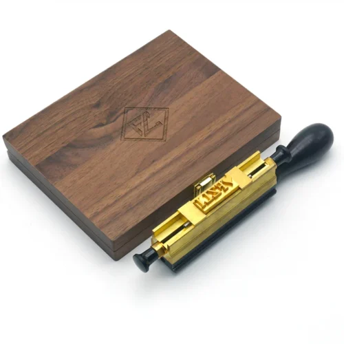 Full set of WT Brand CNC-engraved brass alphabet and number movable type for hot stamping, arranged neatly in a wooden storage box.