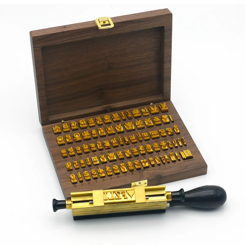 Full set of WT Brand CNC-engraved brass alphabet and number movable type for hot stamping, arranged neatly in a wooden storage box.