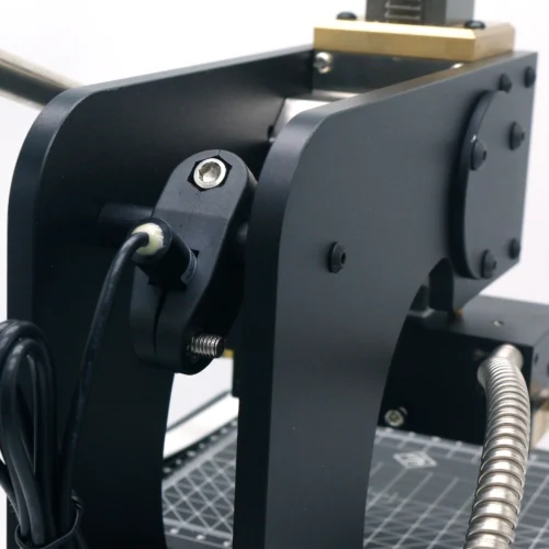 Close-up of ZHENGFEI 90-XTS hot stamping machine lever mechanism for smooth pressure control.