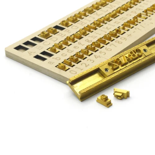 ZHENGFEI Brass Letter Stamps with Type Holder Close-up Detail Close-up of ZHENGFEI 0.01mm CNC engraved brass letter stamps with type holder for leather hot stamping.