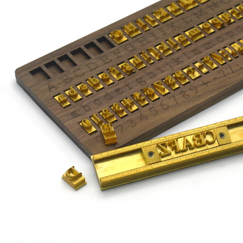ZHENGFEI Brass Letter Stamps with Walnut Box & Type Holder ZHENGFEI CNC engraved brass letter stamps with walnut box and type holder for leather branding.