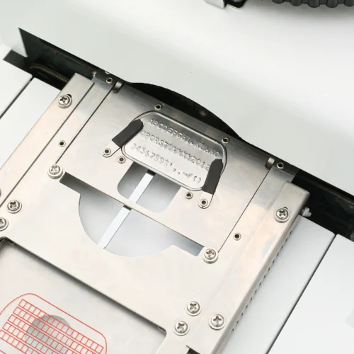 ZHENGFEI Dog Tag Embossing Machine Character Guide Plate Close-up Close-up of ZHENGFEI dog tag embossing machine character guide plate with A-Z, 0-9 and symbols.