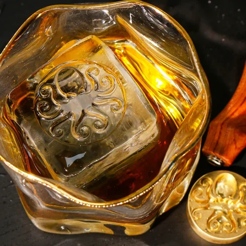 ZHENGFEI octopus design ice cube in whiskey glass, made with custom brass ice stamp.