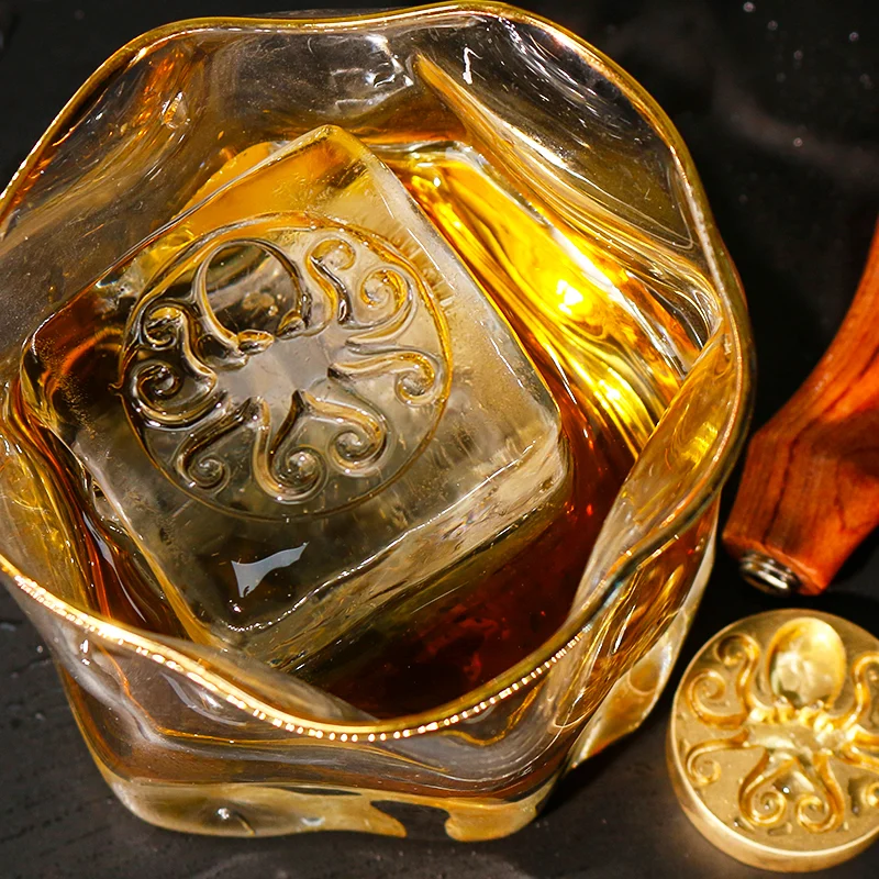 ZHENGFEI octopus design ice cube in whiskey glass, made with custom brass ice stamp.