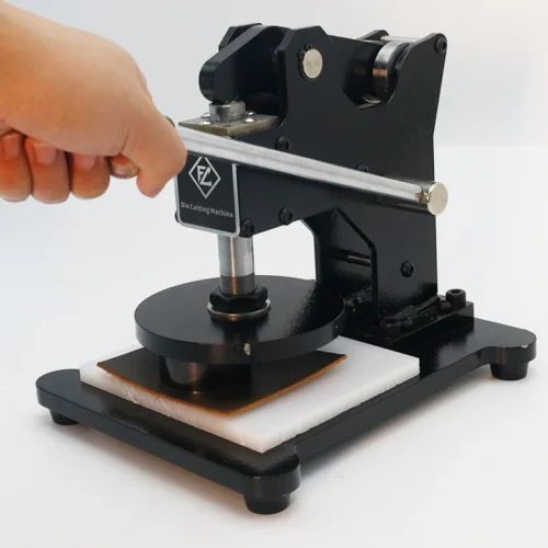ZHENGFEI ZF-SMQ manual die cutting machine in operation, cutting leather material with labor-saving lever handle. ZHENGFEI ZF-SMQ manual die cutting machine in operation, cutting leather material with labor-saving lever handle.