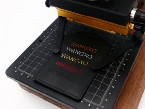 Close-up of ZHENGFEI EC-17 stamping machine worktable with grid alignment and multi-color foil samples.