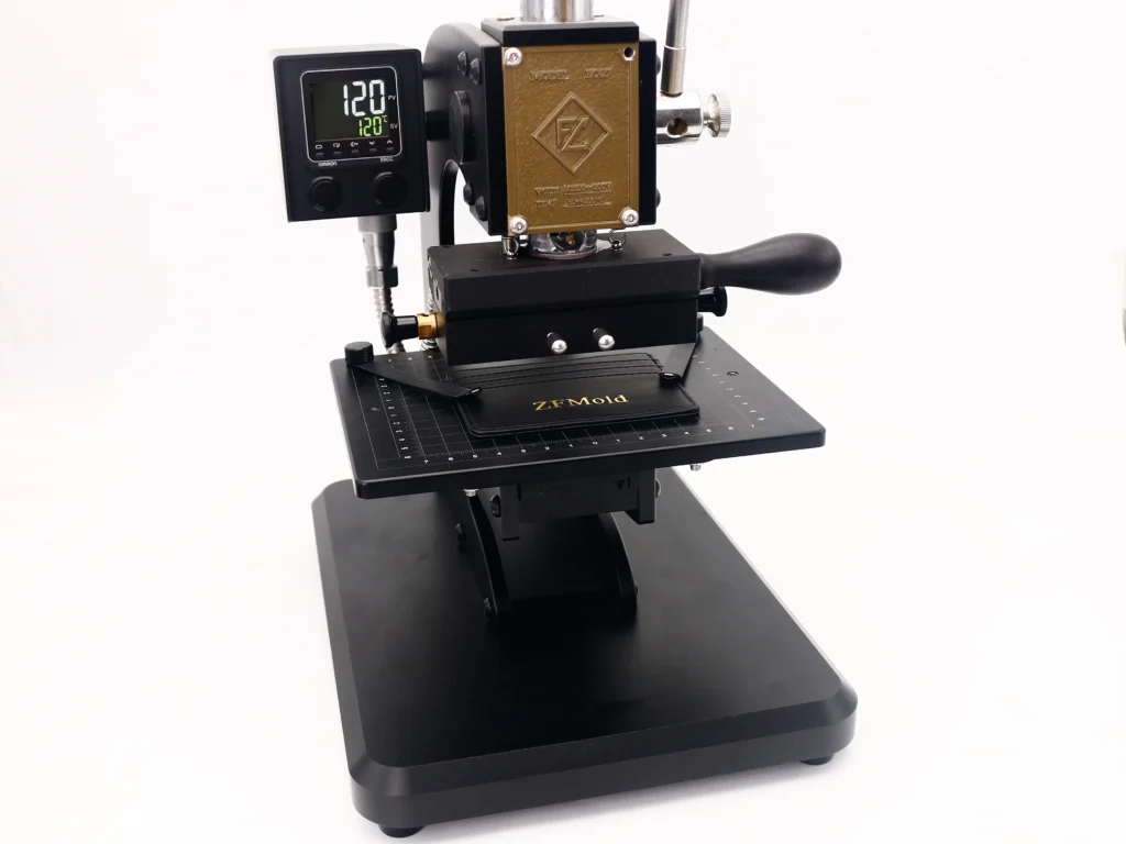 ZHENGFEI EC-27 leather hot stamping machine with digital temp control, stamping gold foil logo on leather card holder.