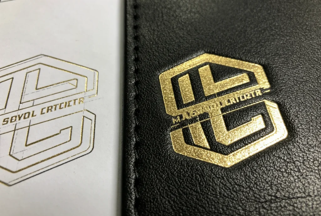 Side-by-side logo vector drawing and finished gold foil stamp on black leather showing solid area transfer accuracy of ZHENGFEI brass mold.