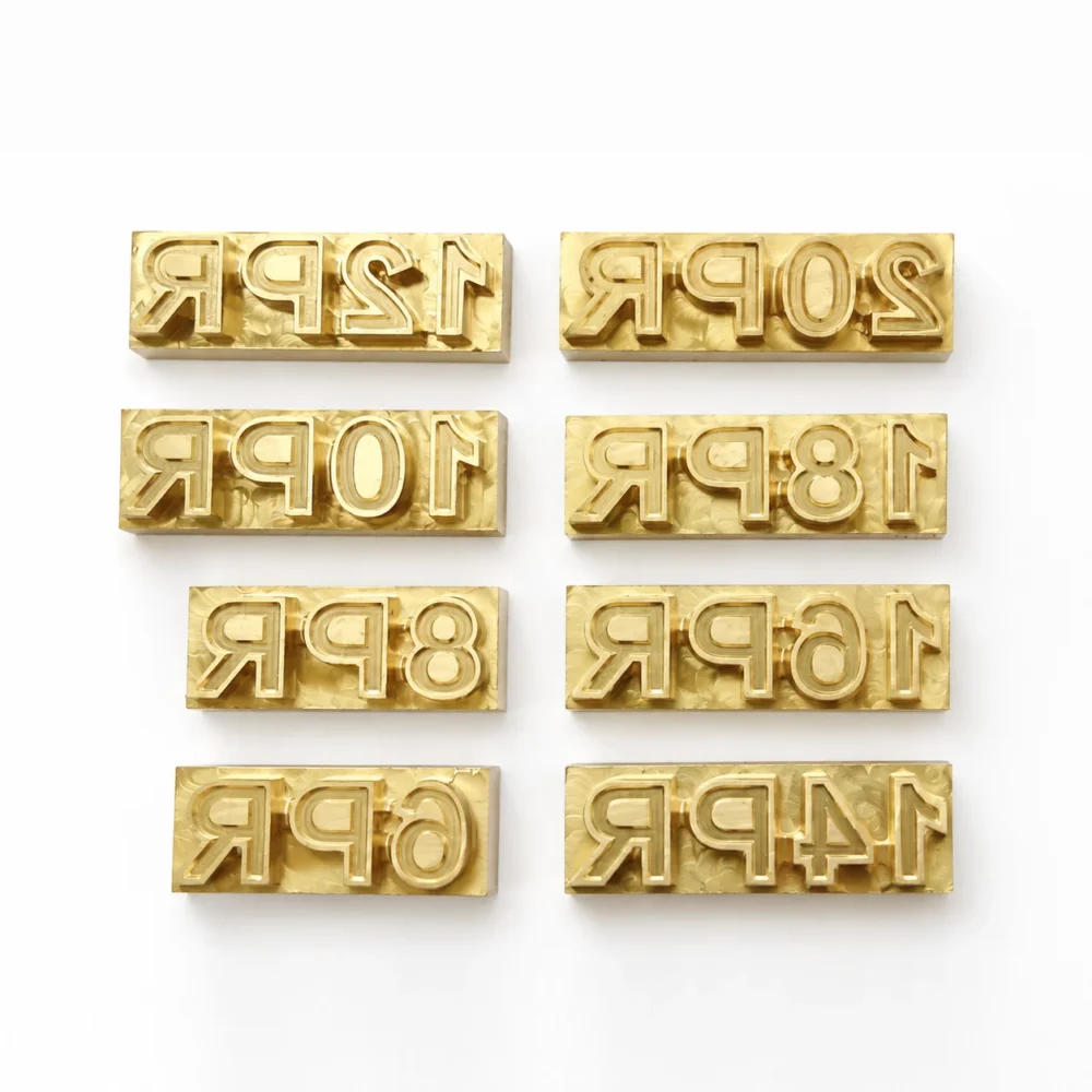 Rectangular brass number & date code stamp strips with R marking CNC engraved on clean white backdrop for batch coding & leather labeling.