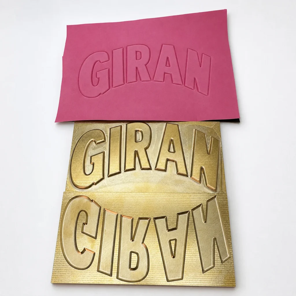 Custom‑text GIRAN 3D relief brass hot stamping die paired with pink silicone counter‑die for leather embossing