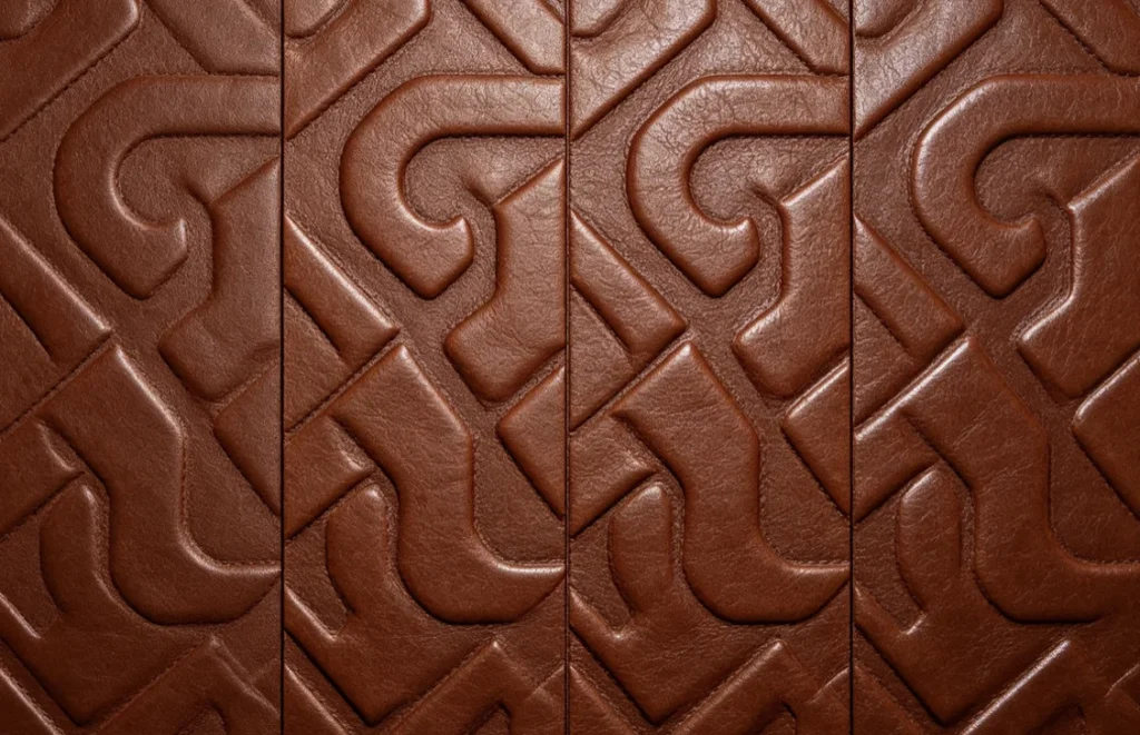 Large‑area repeating geometric ornament 3D leather embossing output from YTJ‑5T hydraulic hot stamping press with brass relief die