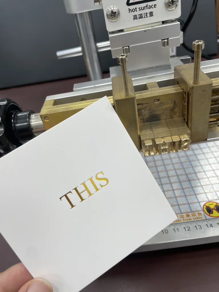 WT-90SK brass die stamping gold foil lettering onto glossy cardstock