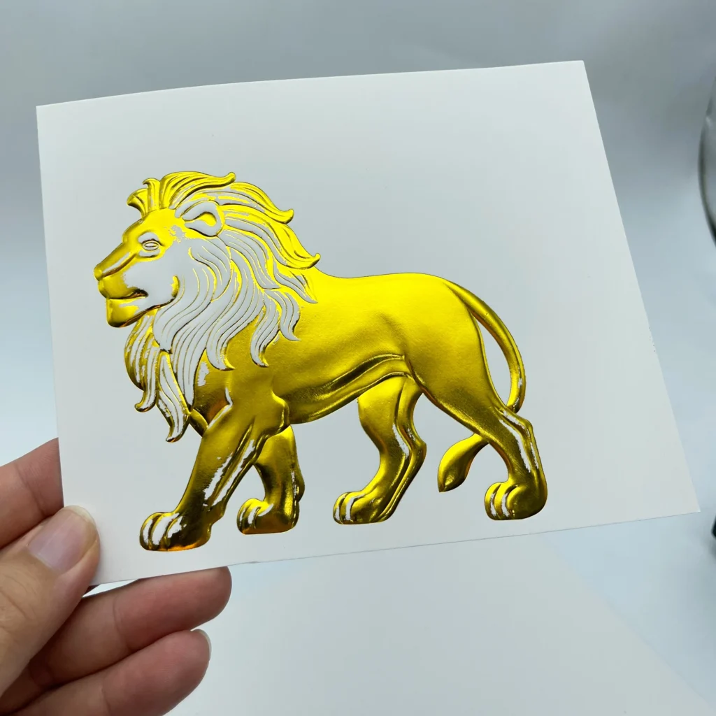 WT-QY300 hot stamping machine gold lion relief foil sample on glossy cardstock, test at 120°C with partial foil transfer