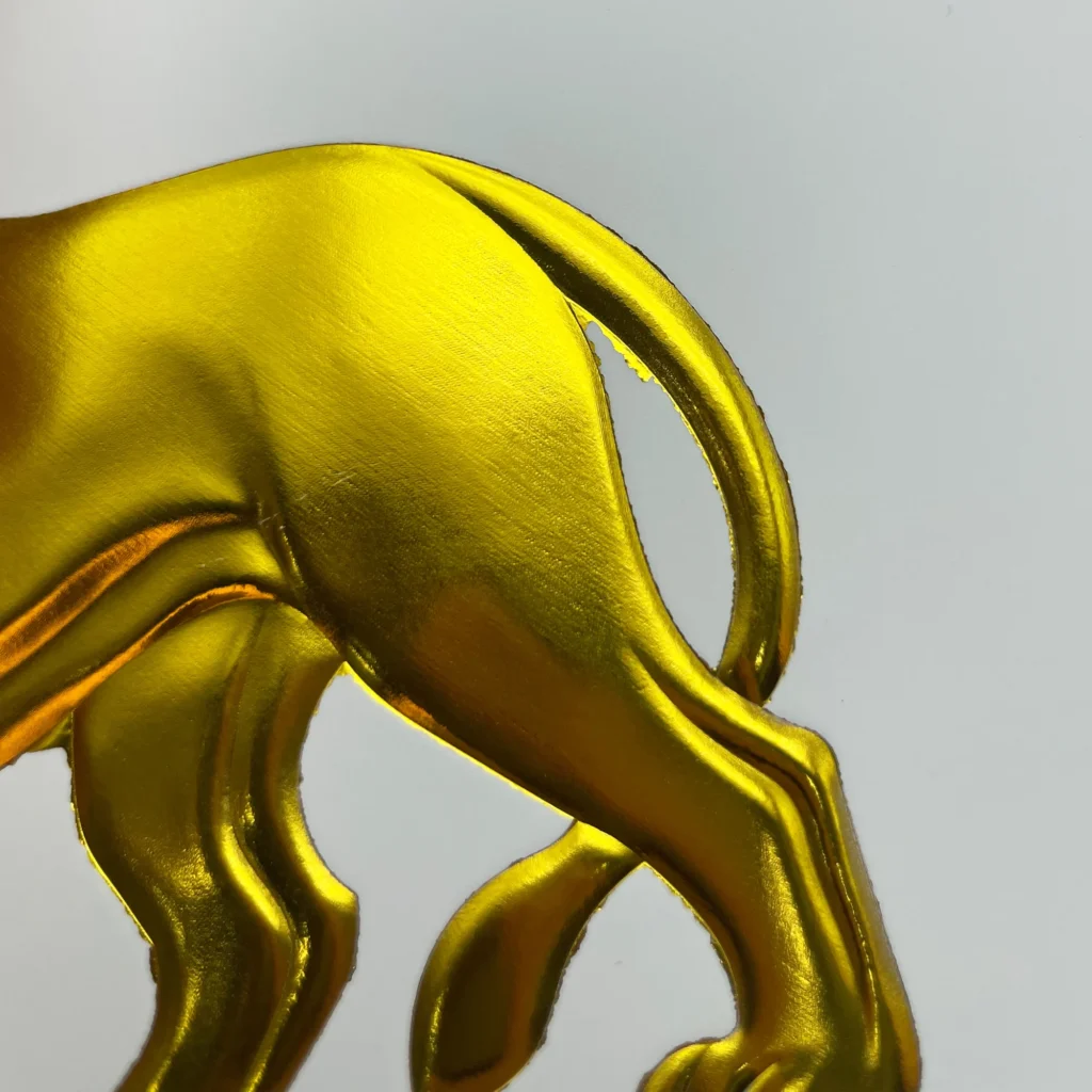 WT-QY300 hot stamping machine closeup of gold lion tail and leg relief foil stamped on glossy cardstock at 150°C