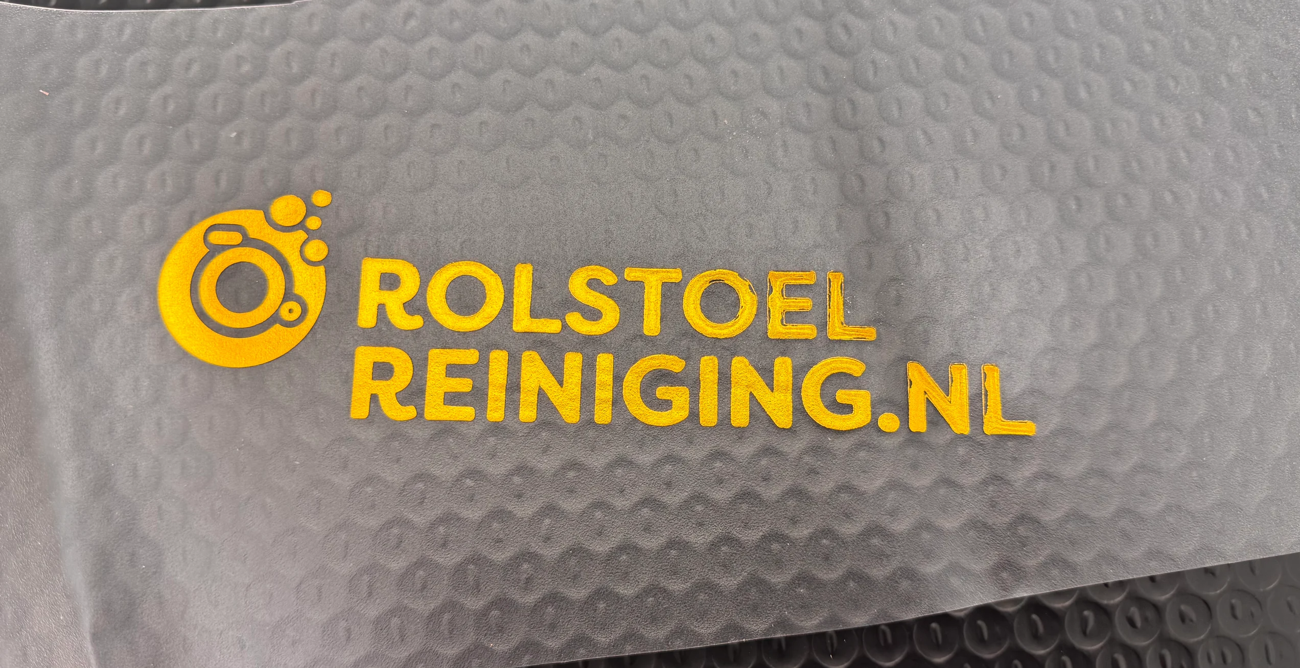 WT-QY300 stamps a gold logo on soft PVC in a sample labeled 110°C